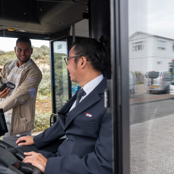 Buschauffeur verwelkomt reiziger Buschauffeur verwelkomt reiziger