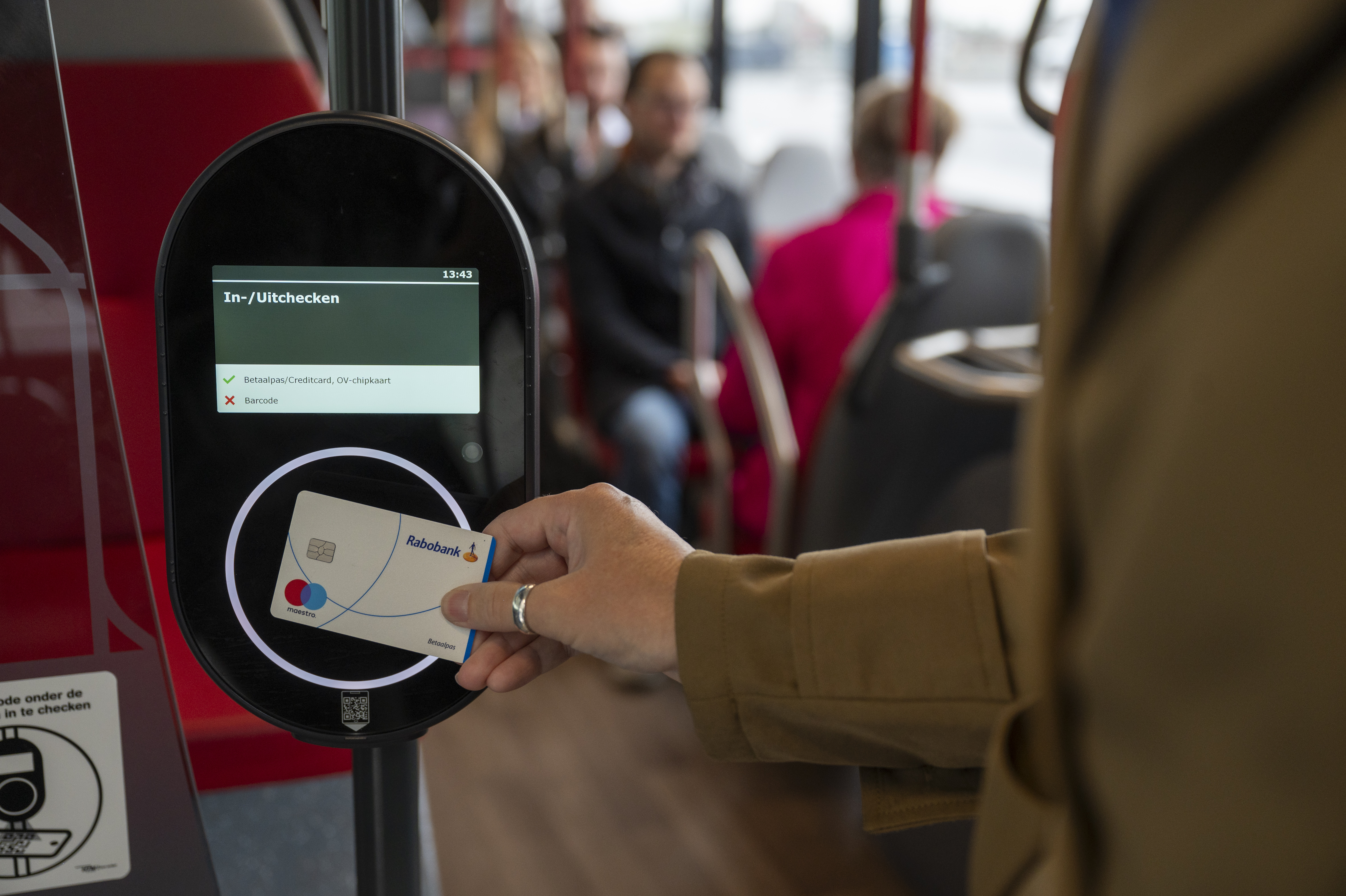 Reiziger checkt in met betaalpas in bus