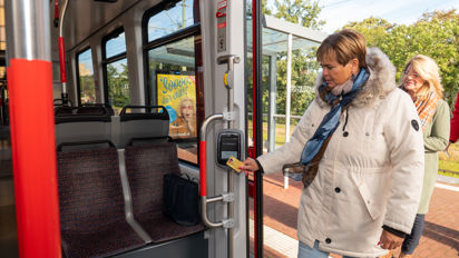 Vrouw checkt in met OV-chipkaart Reiziger checkt in met OV-chipkaart