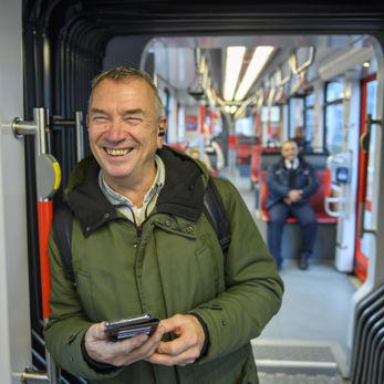 Man staat in tram Man staat in HTM tram en lacht naar de cameras
